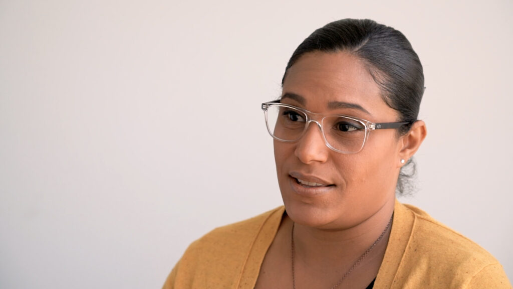 Woman with glasses and a yellow cardigan