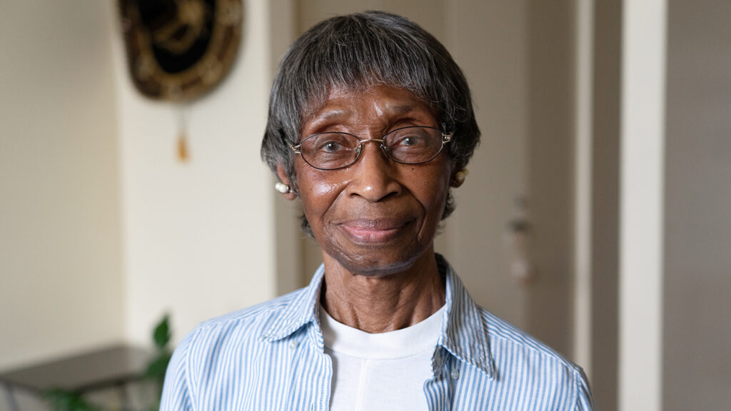 older woman with glasses and gentle smile