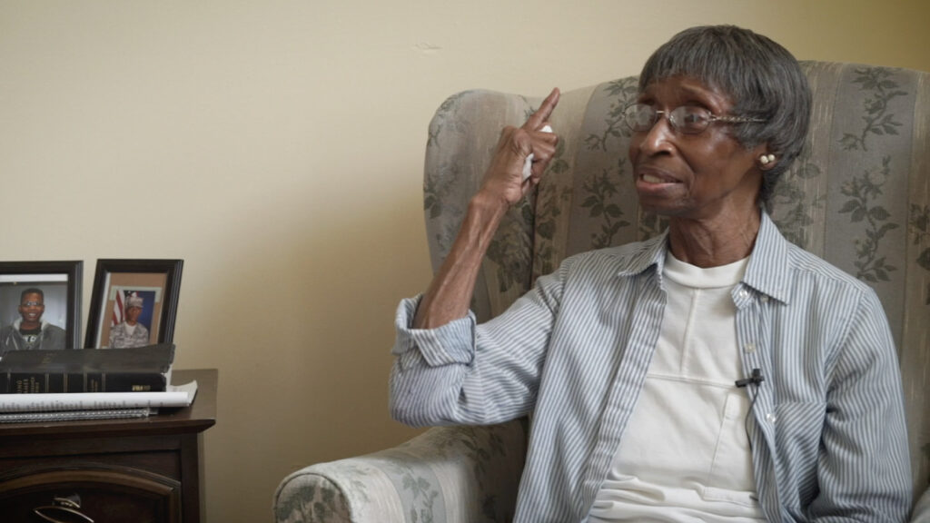 older woman pointing with raised hand