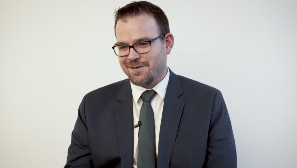 man with glasses in suit and tie