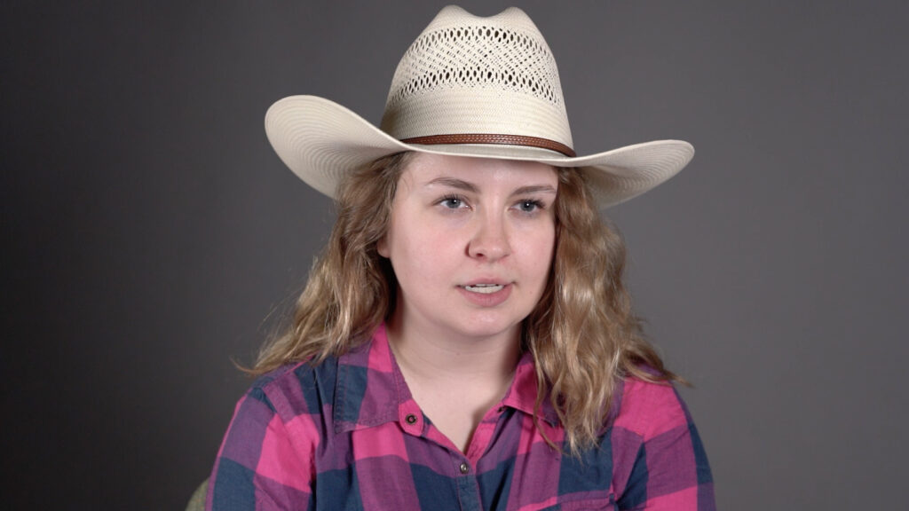 woman with long hair in a cowboy hat