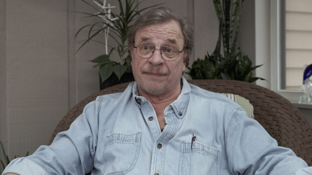 man with glasses in blue jean work shirt