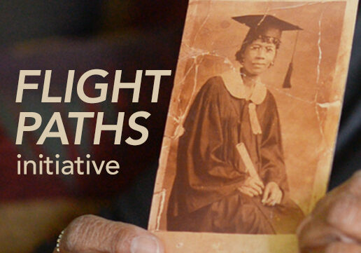 hands holding archival photograph of African American woman in cap and gown