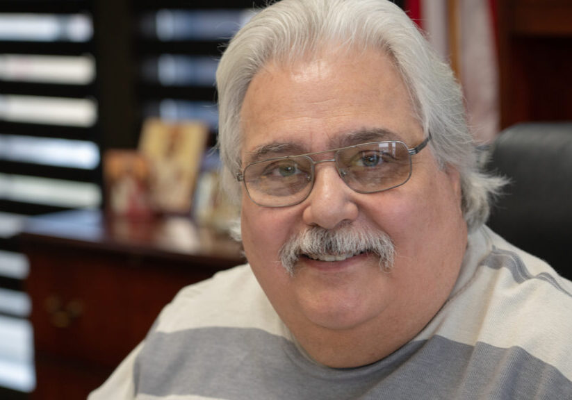 smiling man with moustache and glasses