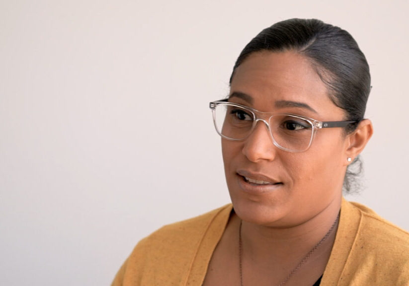 Woman with glasses and a yellow cardigan