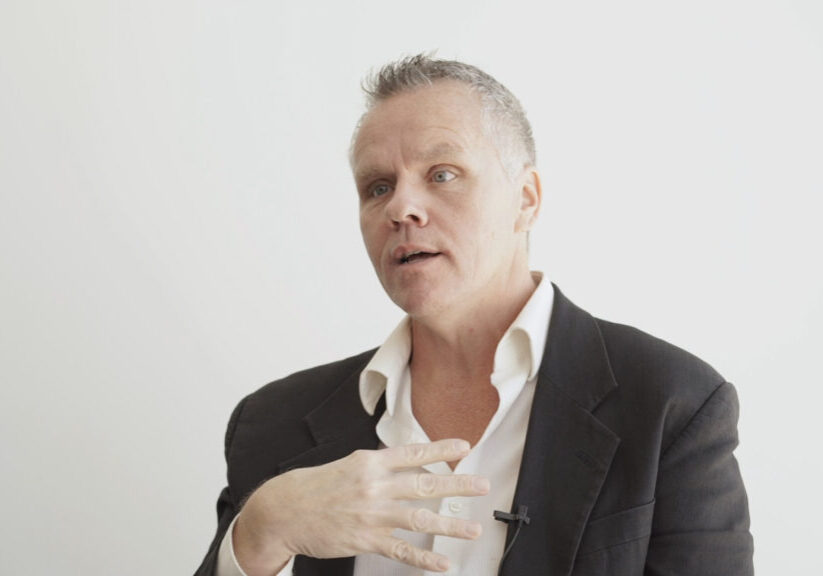 middle-aged man in blazer speaking
