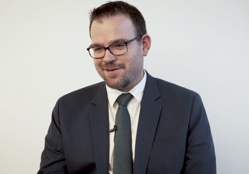 man with glasses in suit and tie