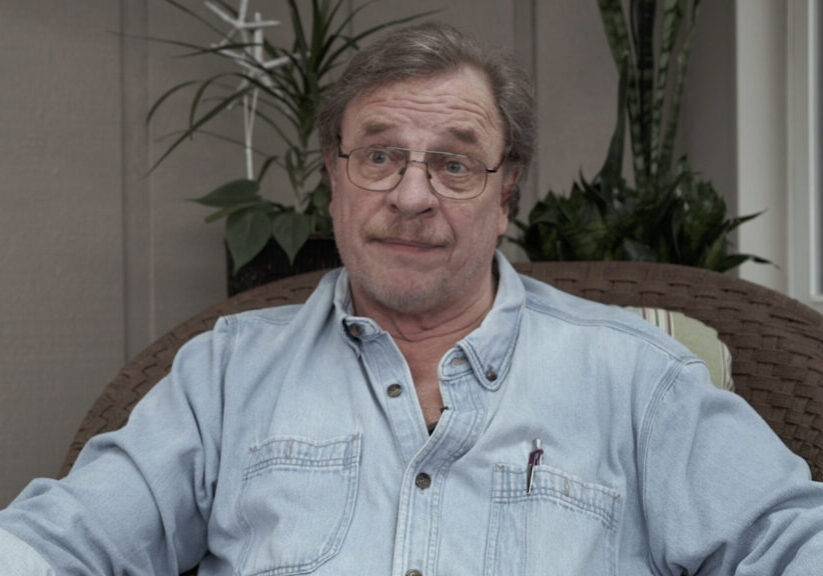 man with glasses in blue jean work shirt